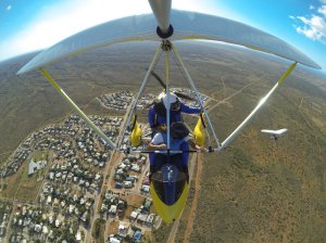 Two microlites in flight over Exmouth - Steve in front and Jane below